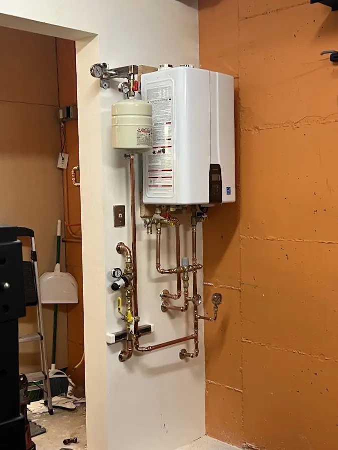 Plumbing technician inspecting water heater connections in Boyes Hot Springs